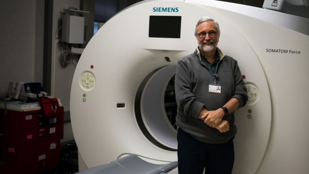 Dr. Eric Hoffman standing in front of a CT scanner